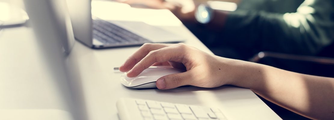 Close up of people's hand working on computer