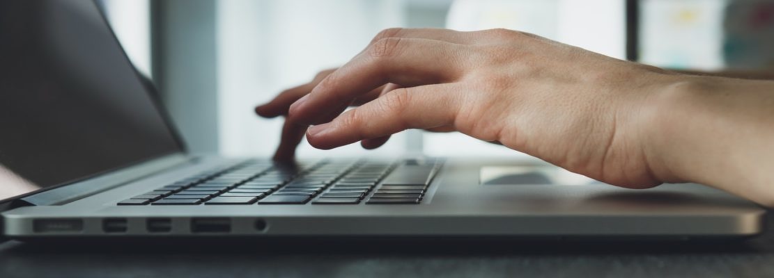 woman's hands working on laptop computer