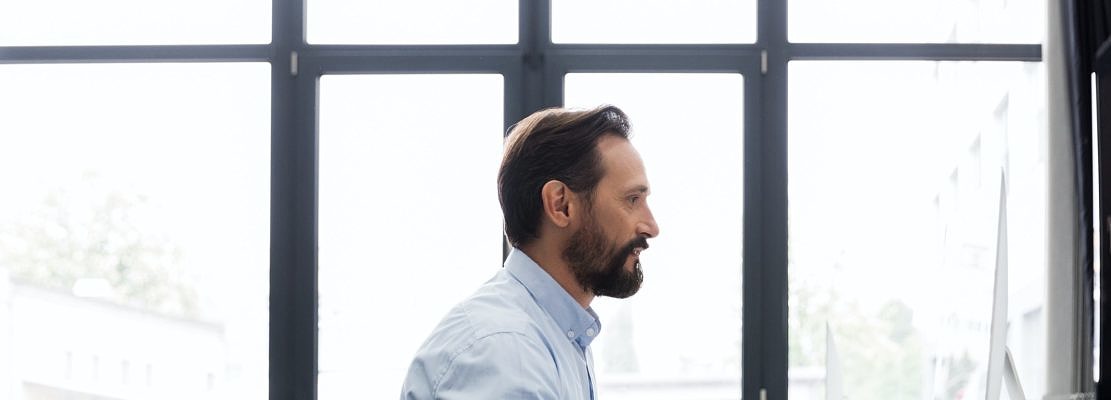 Side view of a business man working on a computer