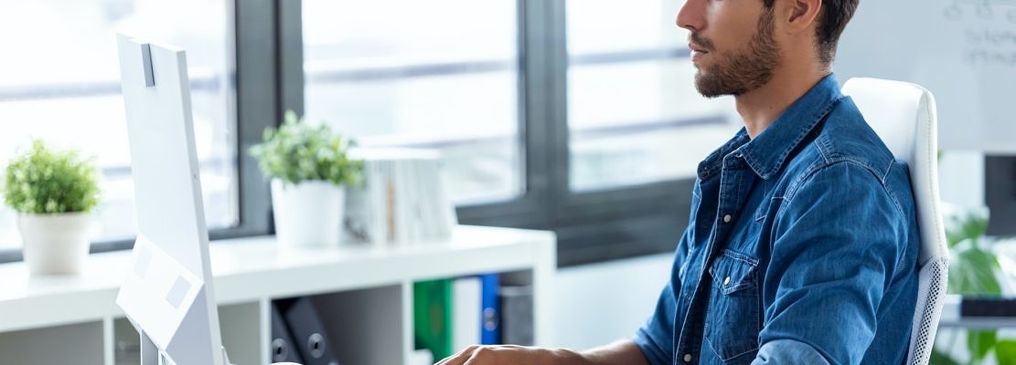 Software developer working with computer in the modern startup office.