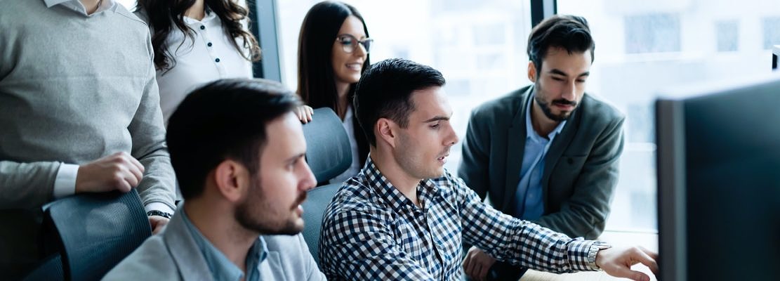 Young businesspeople working on computer in office