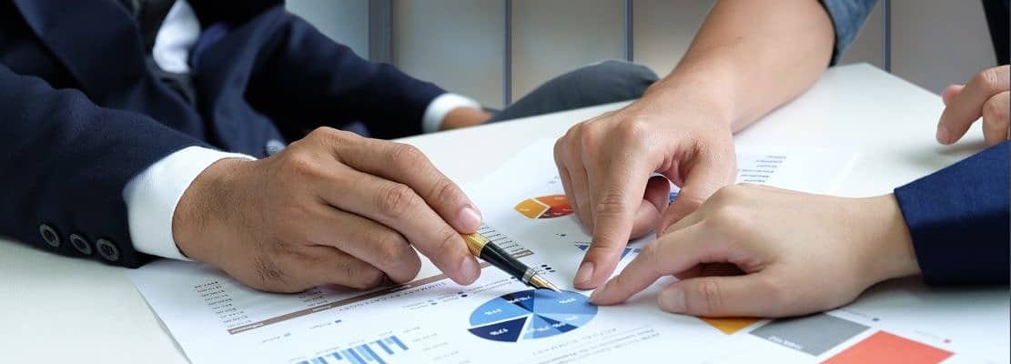 Businessteam are analyzing graphs data.
