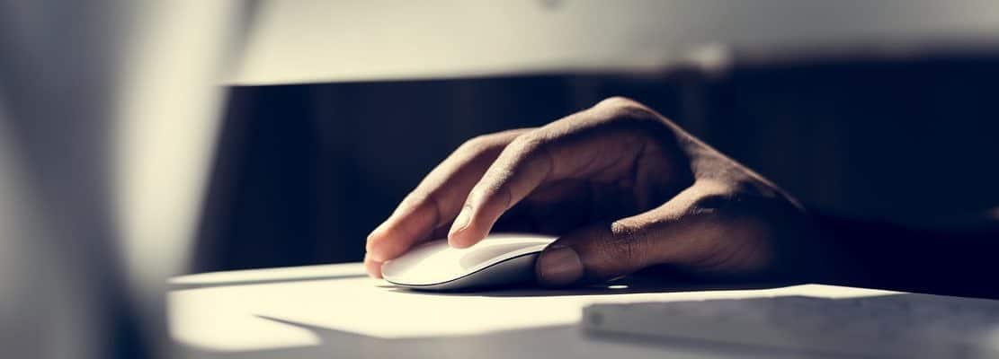 Close up of hand using a computer