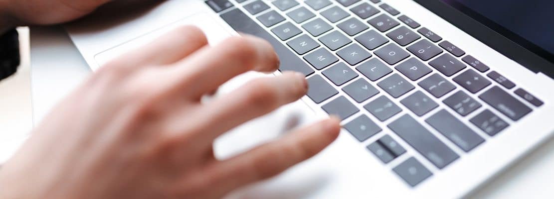 Photo of man hands typing on laptop
