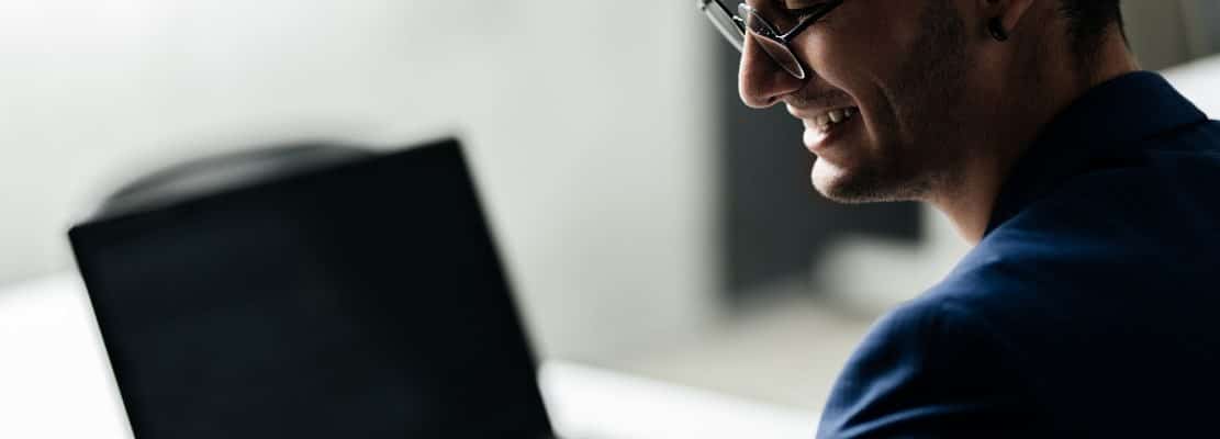Professional architect dressed in a business suit works on the laptop in the office