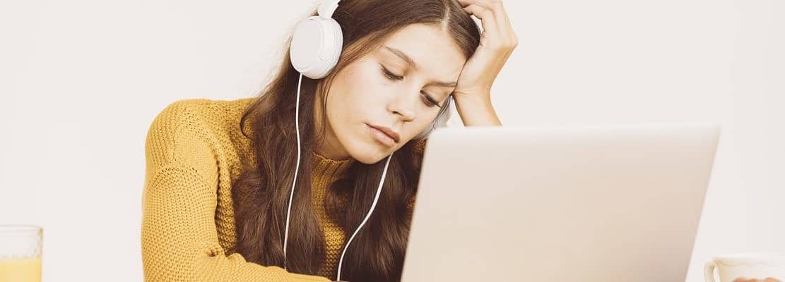 Young girl fell asleep in front of laptop. Cute woman is bored
