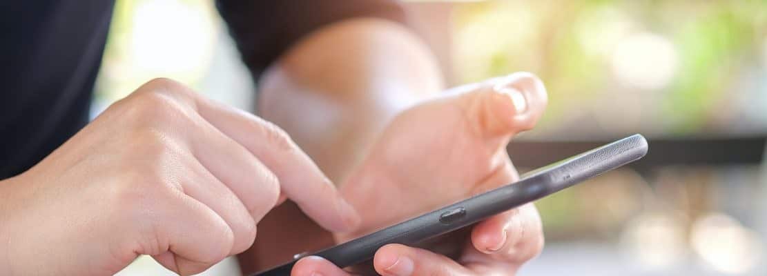 Hand holding a smartphone with white.