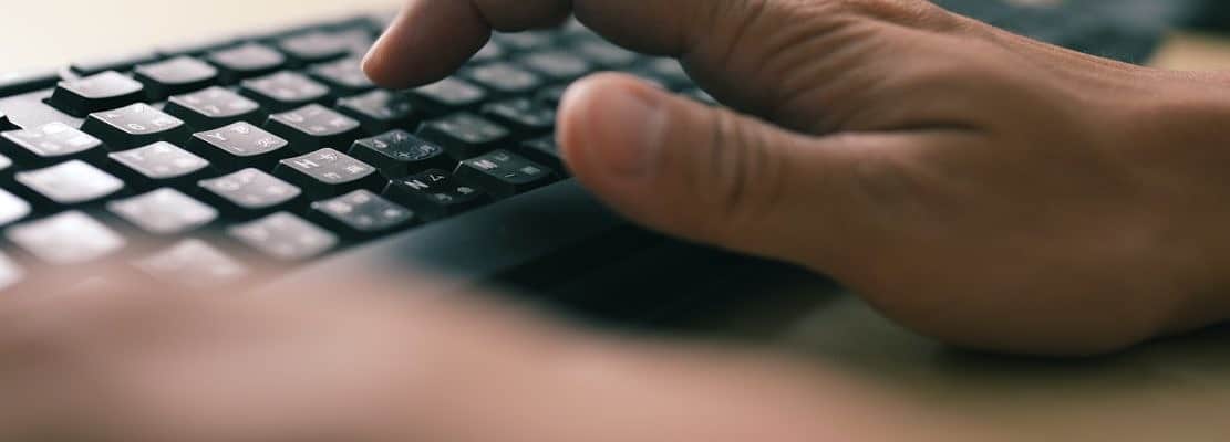 Man hands typing on a computer keyboard