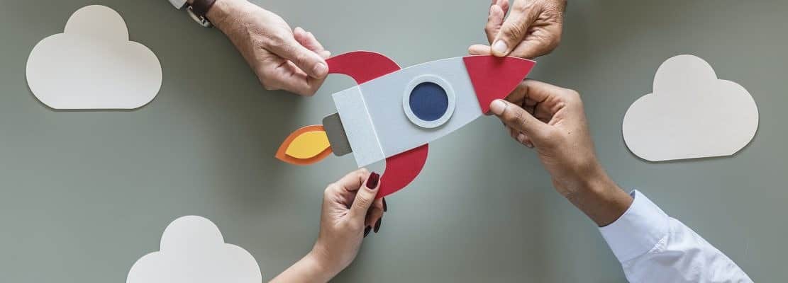 Business people with startup rocket