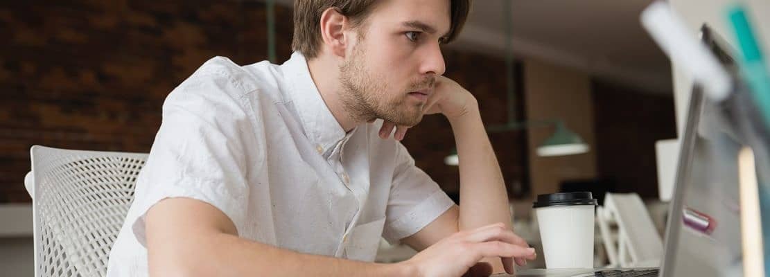 Executive using laptop in office