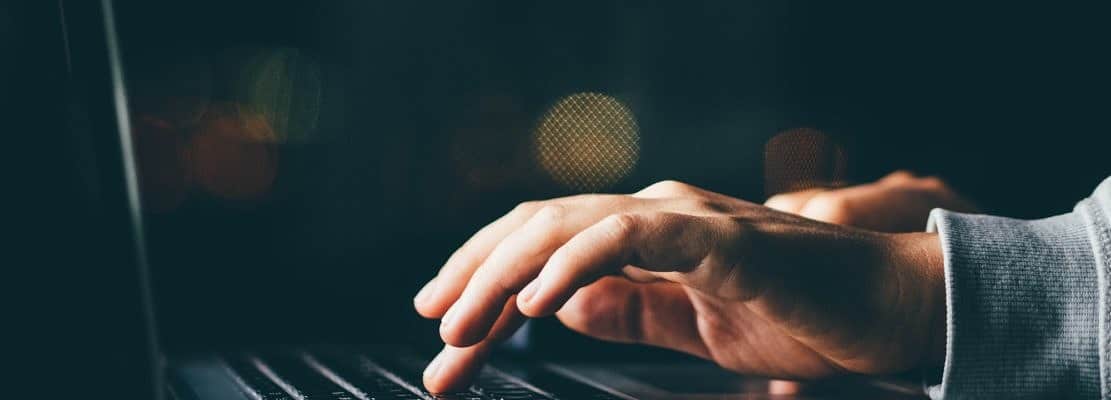 Close up hand with laptop.