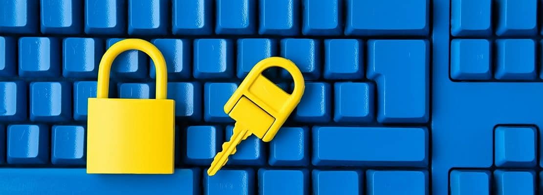Cyber data and information security idea. Yellow padlock and key and blue keyboard. Computer