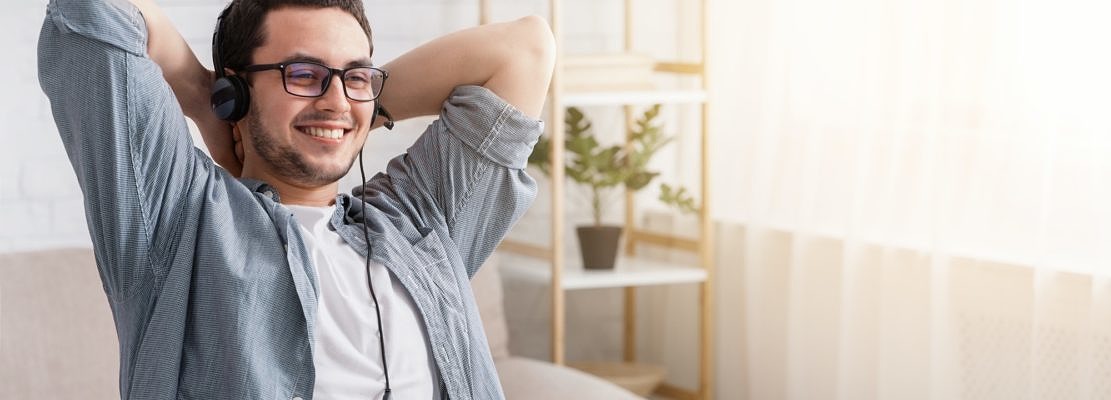 Online webinar and remote work. Man in headset with laptop at home