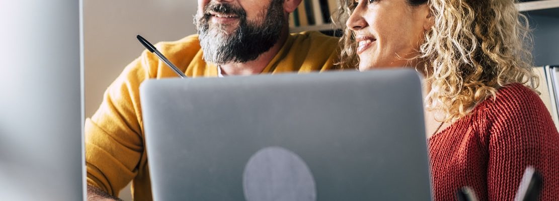 People at work at home with internet connection and computer laptop in couple - man and woman