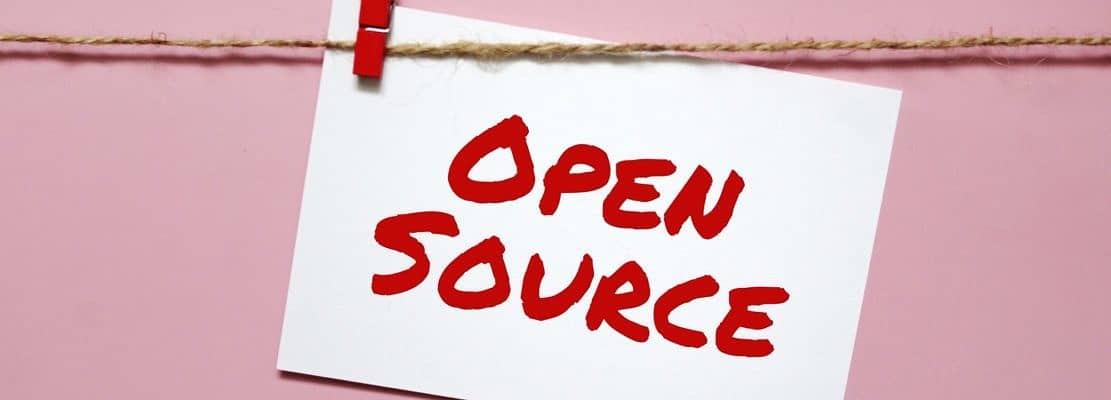 Sticker with the inscription open source hanging on a rope on a pink background