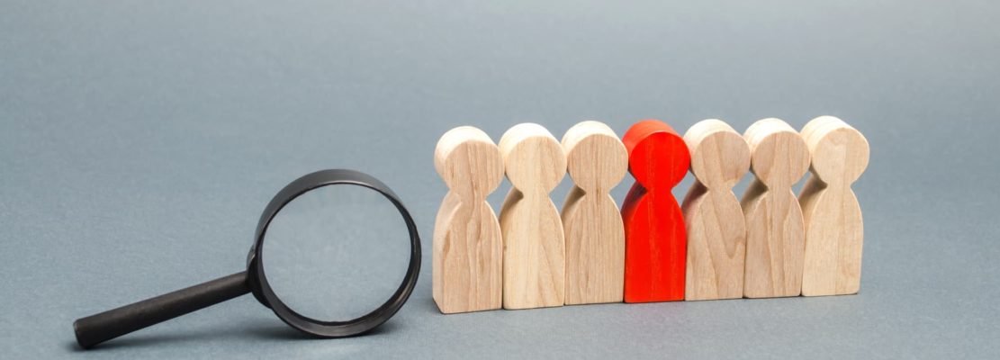 Team of workers and magnifying glass