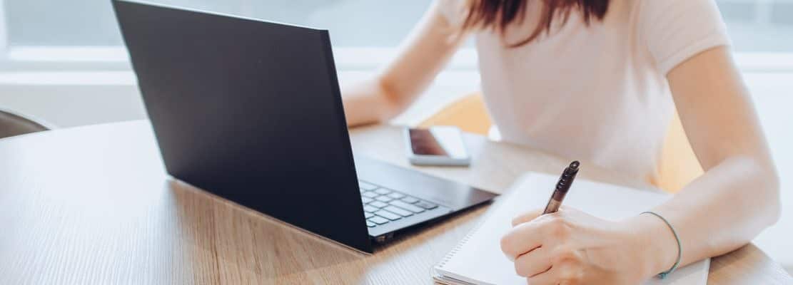 Young woman writing in the office