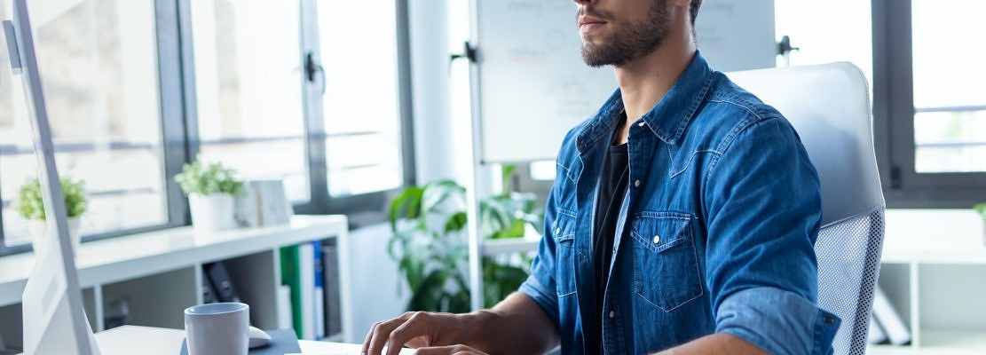 Software developer working with computer in the modern startup office.