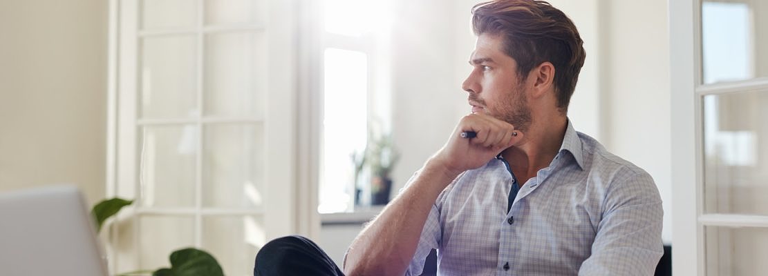 Thoughtful businessman sitting home office