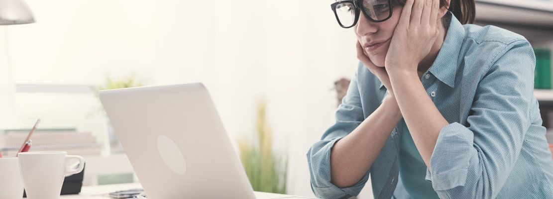 Bored woman working with her laptop