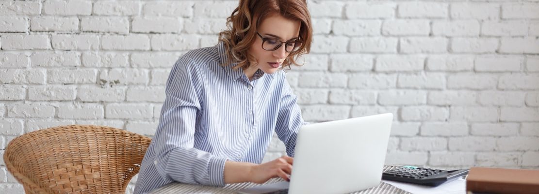 Young woman freelancer works at the computer.