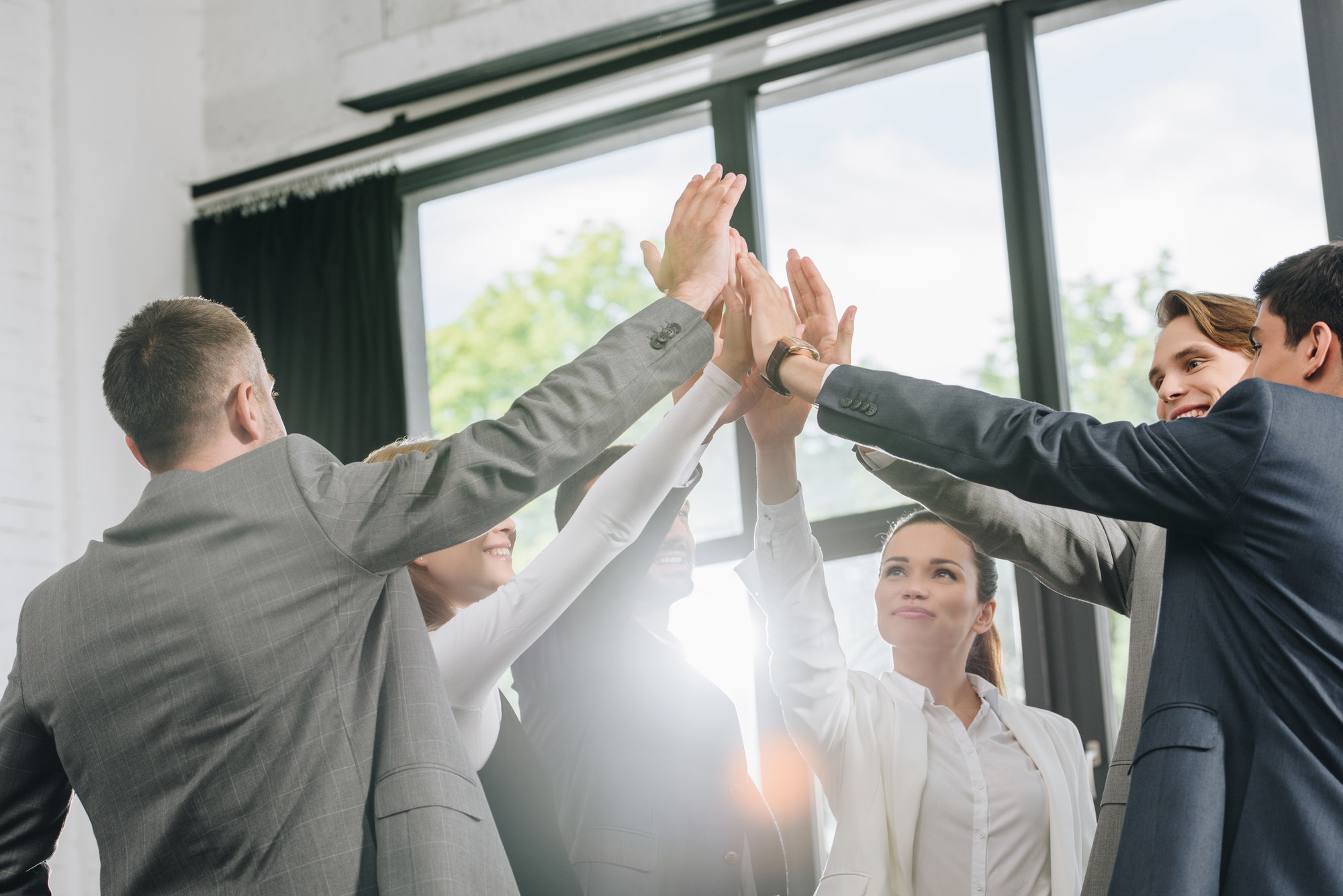 businesspeople giving high five after training in hub businesspeople giving high five after training in hub