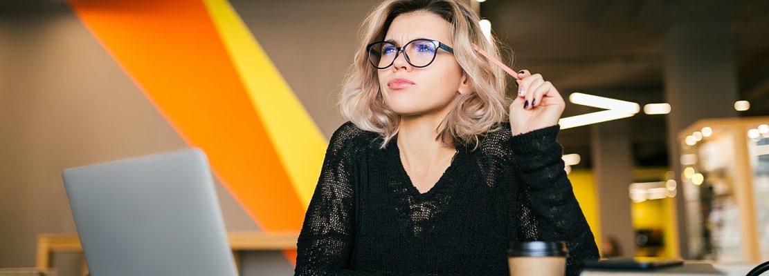 young woman working on laptop in co-working office