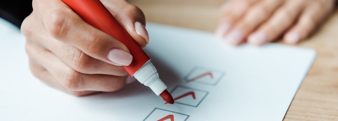 cropped view of woman putting check park in check list