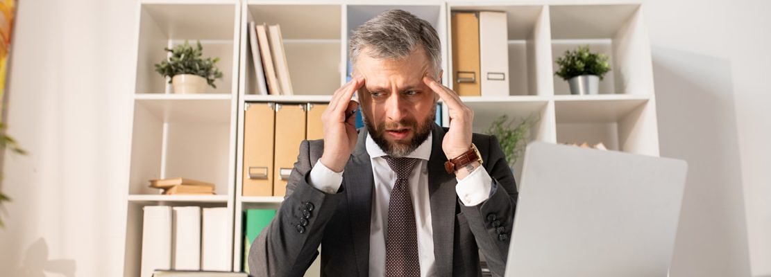 Depressed businessman confused with paperwork