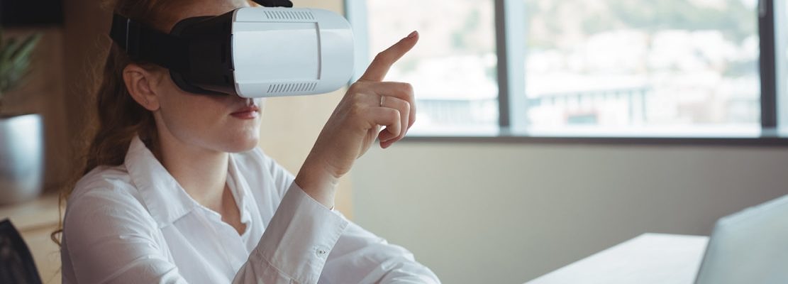 Businesswoman using virtual reality technology in office