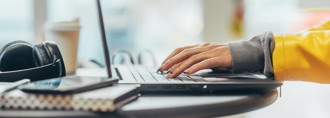 Hands of a woman using a laptop