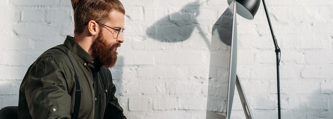 side view of handsome businessman using computer in office