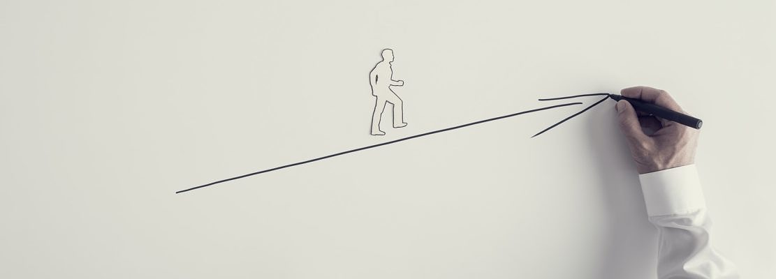 Paper silhouette cutout of a man and male hand drawing upward arrow