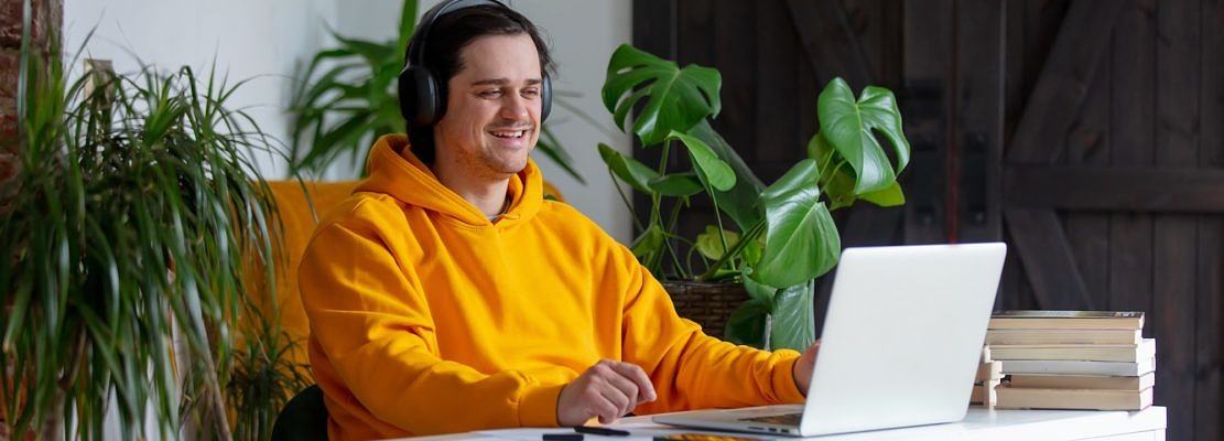 Young man in headphone working at home office