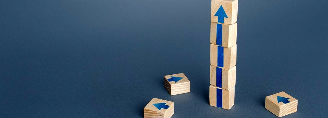 Block tower with arrows. Growth, development progress concept. Achieve success. Career promotion