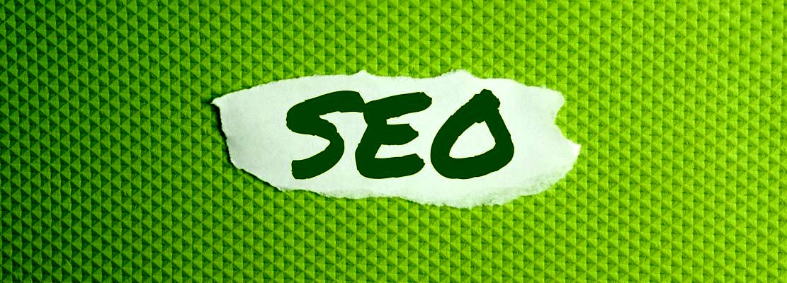 a torn paper written with inscription SEO on a green background