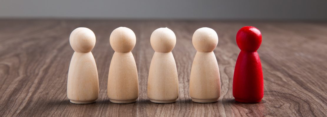 Wooden people figures on top of wooden blocks. Career growth, development and leadership