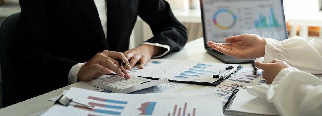 financial adviser working calculating and analysis budget numbers at modern office , Business people