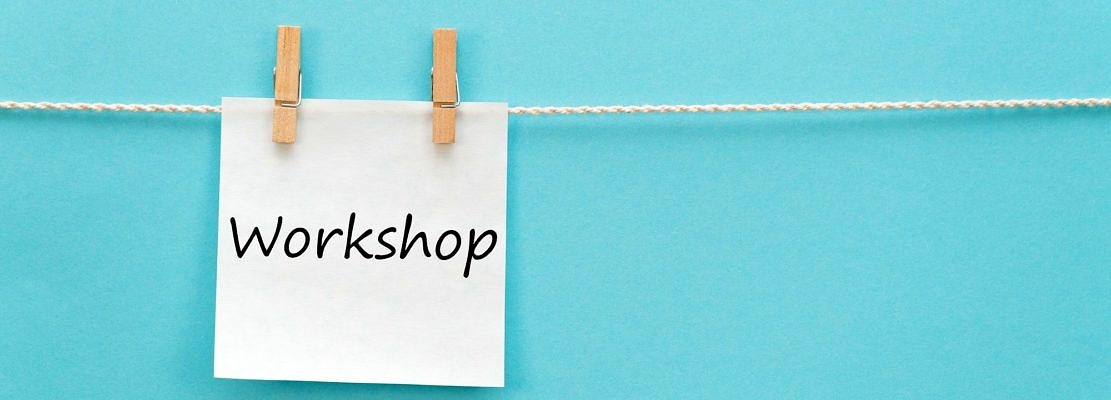 sticker with the inscription Workshop hangs with a clothespin on a rope on a blue background