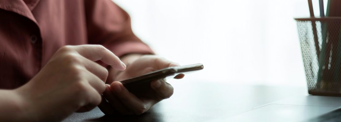 Close up hand of woman using smart phone