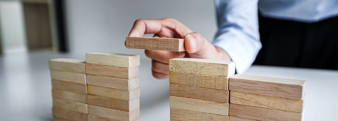 Business Growth Concept With Wooden Blocks, hand of woman has piling up and stacking a wooden block