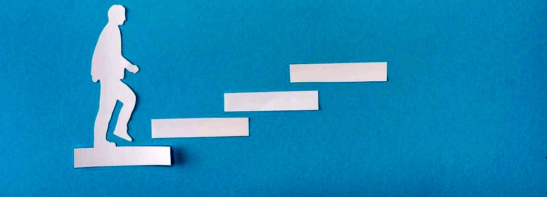Top view of paper man on career ladder on blue