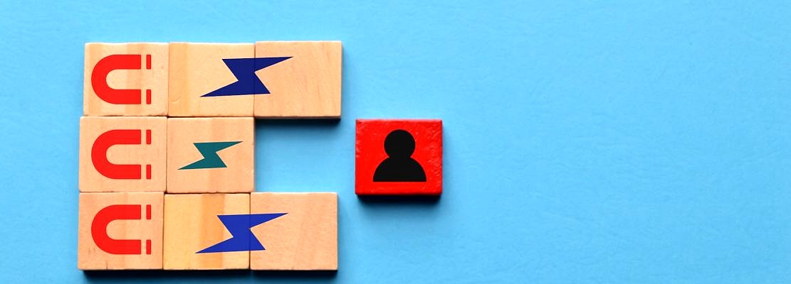 Wooden cubes with magnet icons pull a person in a row blocks. Recruiting and search talent workers