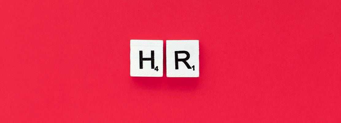 HR scrabble letters word on a pink background