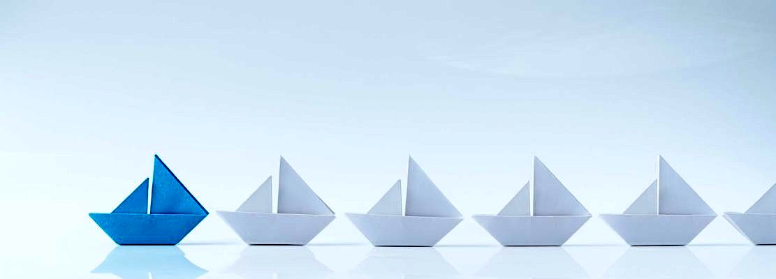 Leadership conceptual using blue paper ship