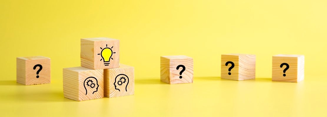 Lightbulb icon and brainstorming print screen on wooden block cube. It is creative thinking idea