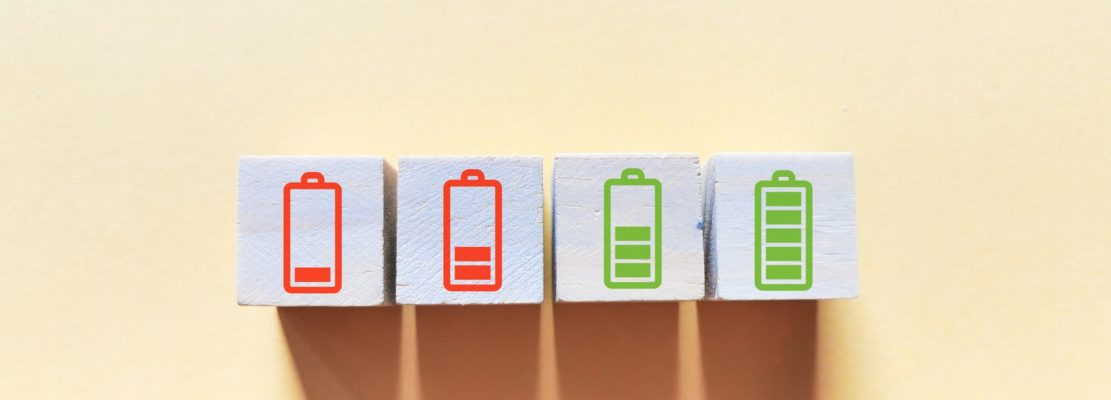 Enthusiasm employee concept with battery icons on wooden cubes.
