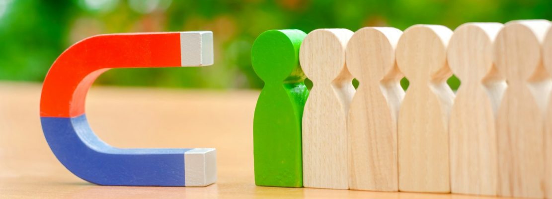 Wooden figures of people and a magnet