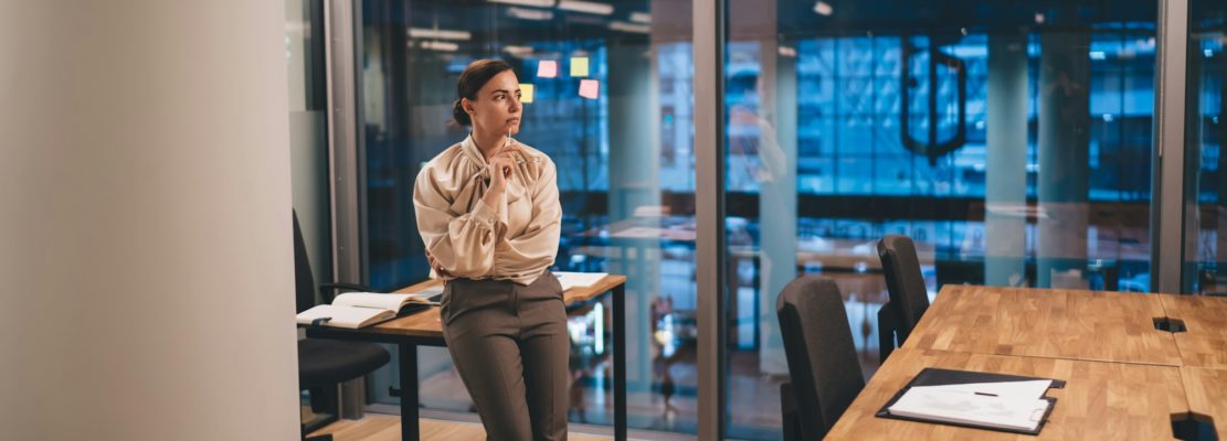 Businesswoman thinking about project in modern office