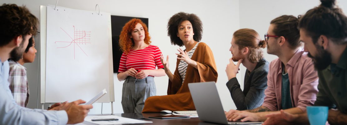 Happy african american female leader holding negotiations meeting with friendly diverse colleague